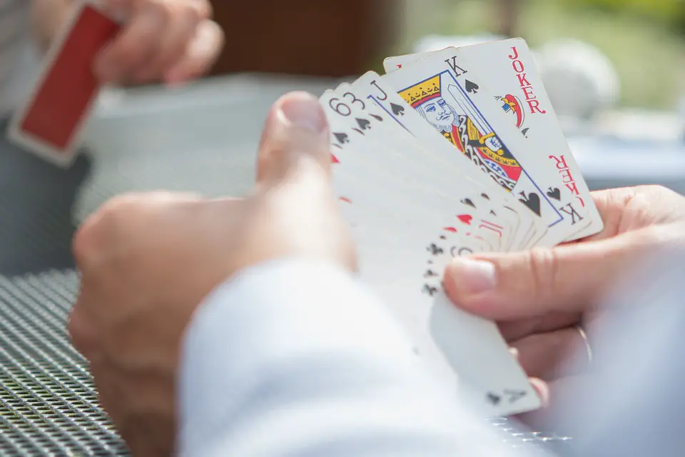 Two Men Playing Cuarenta Card Games with on a coffee shop
