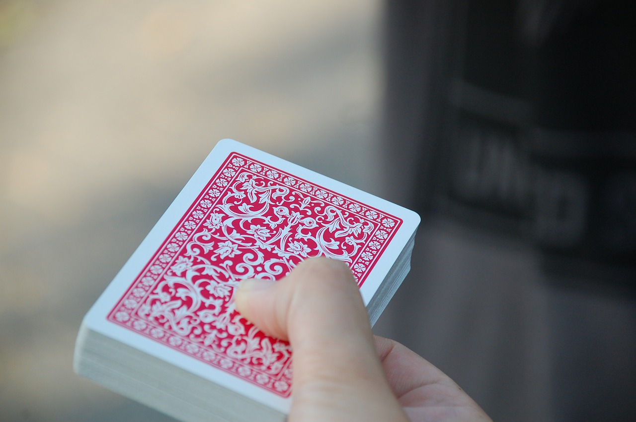 person holding a deck of cards